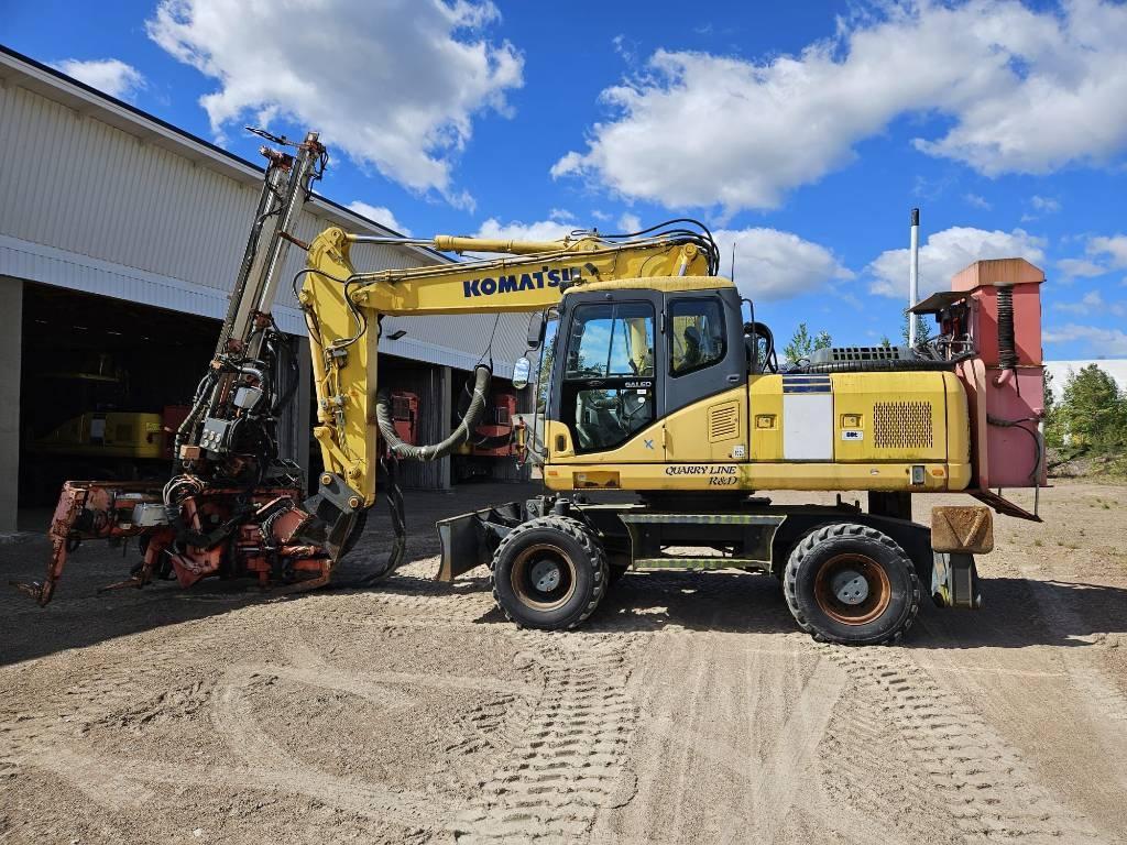 Sandvik DQ 240 ja Komatsu PW 180-7K Avolouhintaporauslaitteet